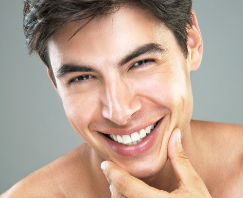 a man smiling after dermal fillers
